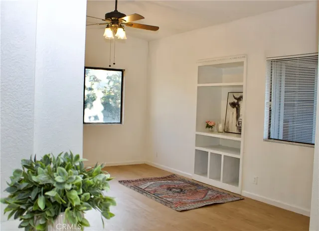 a living room with a bed furniture and a potted plant