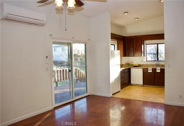 a large kitchen with a large window and stainless steel appliances
