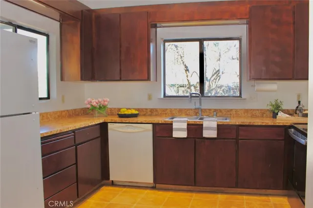 a kitchen with sink window and cabinets