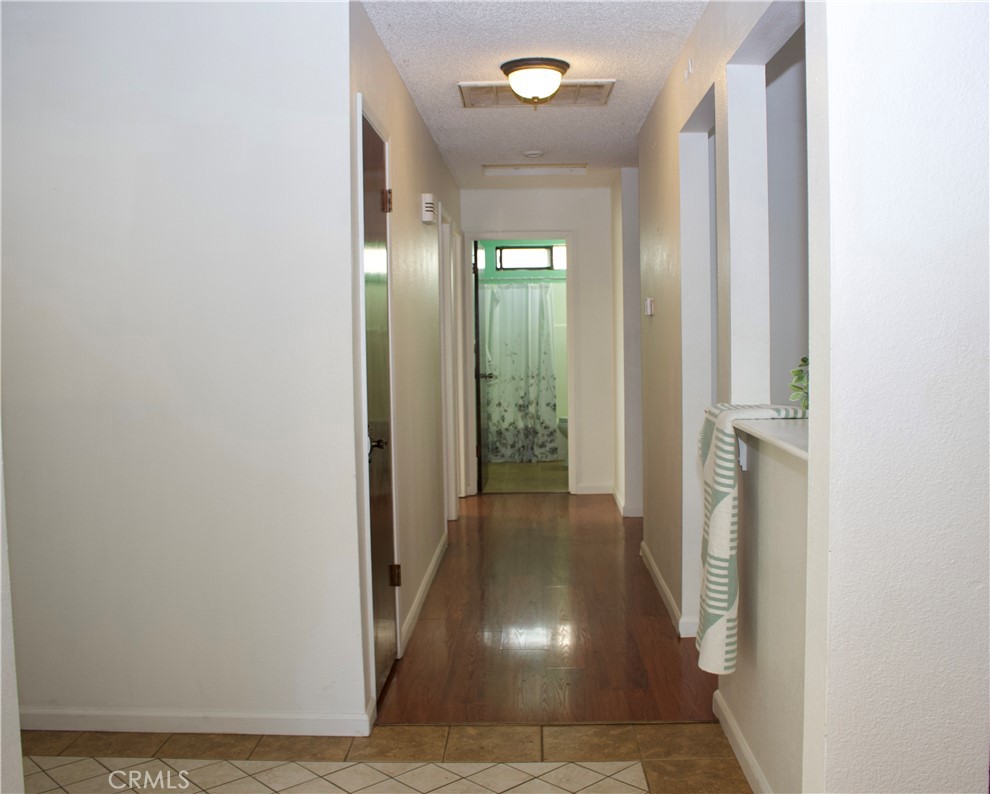 19908 Bear Valley Road Hidden Valley Lake, CA 95467 - Photo 49 of 50 a view of a hallway with wooden floor and a living room