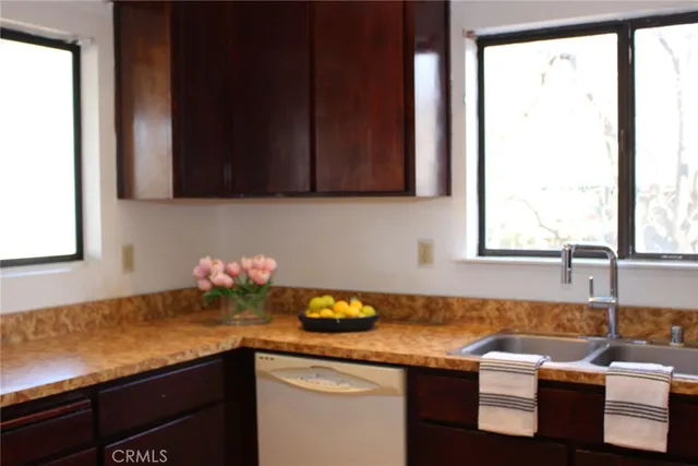 a kitchen with granite countertop sink cabinets and window