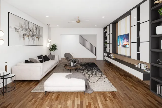a living room with furniture floor to ceiling window and kitchen view