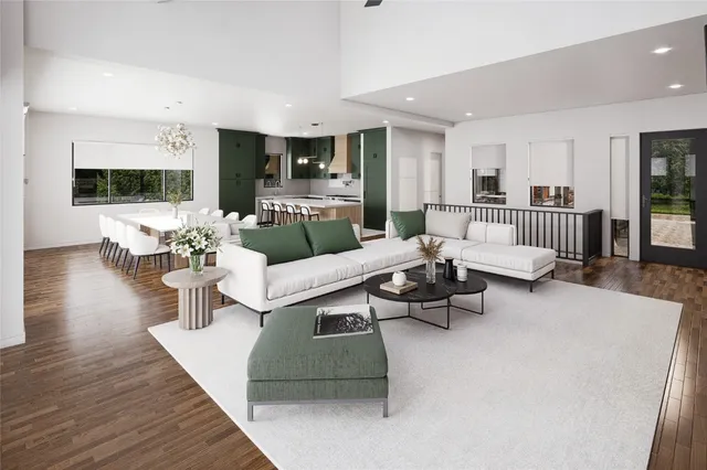 a kitchen with stainless steel appliances kitchen island granite countertop a table chairs sink and cabinets