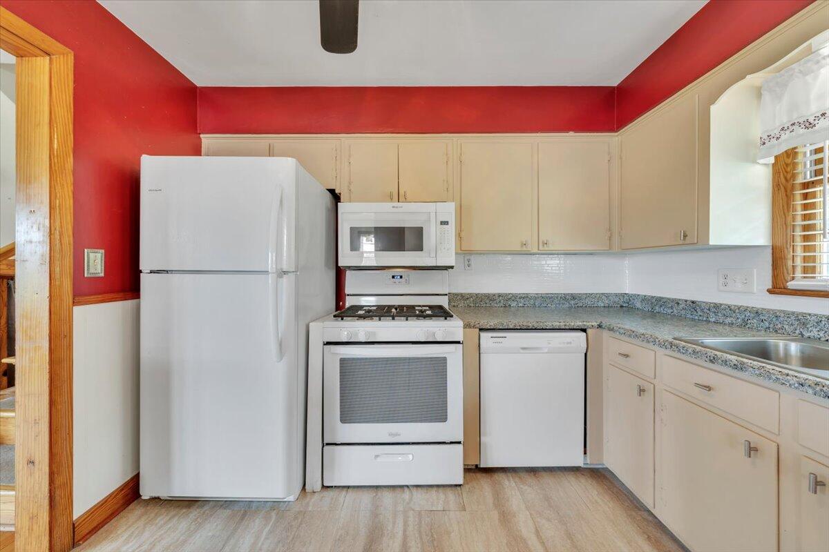 2515 Northminster Road Northwest Roanoke, VA 24012 - Photo 14 of 54 a kitchen with a refrigerator a stove a microwave and wooden floor