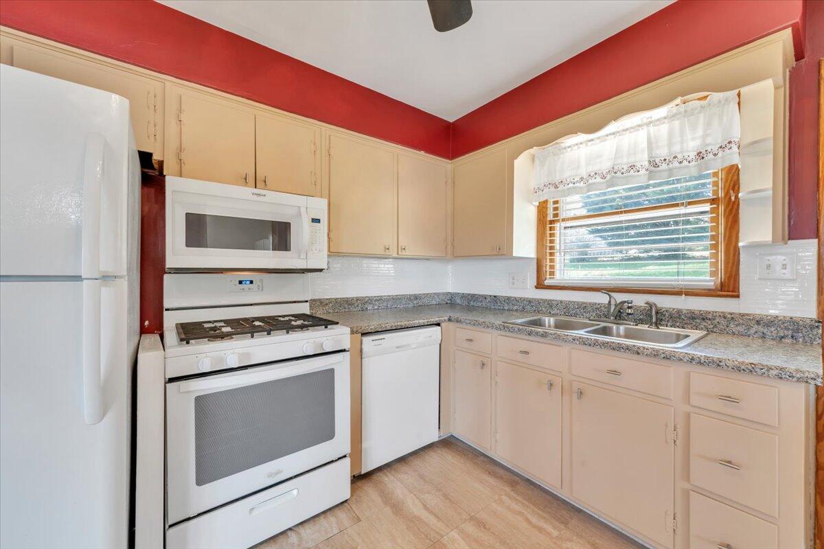 2515 Northminster Road Northwest Roanoke, VA 24012 - Photo 15 of 54 a kitchen with stainless steel appliances granite countertop a stove a sink and a microwave