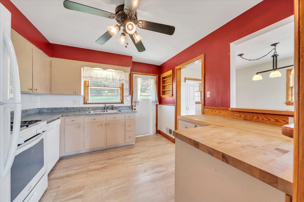 2515 Northminster Road Northwest Roanoke, VA 24012 - Photo 16 of 54 a open kitchen with granite countertop a stove a sink and a refrigerator