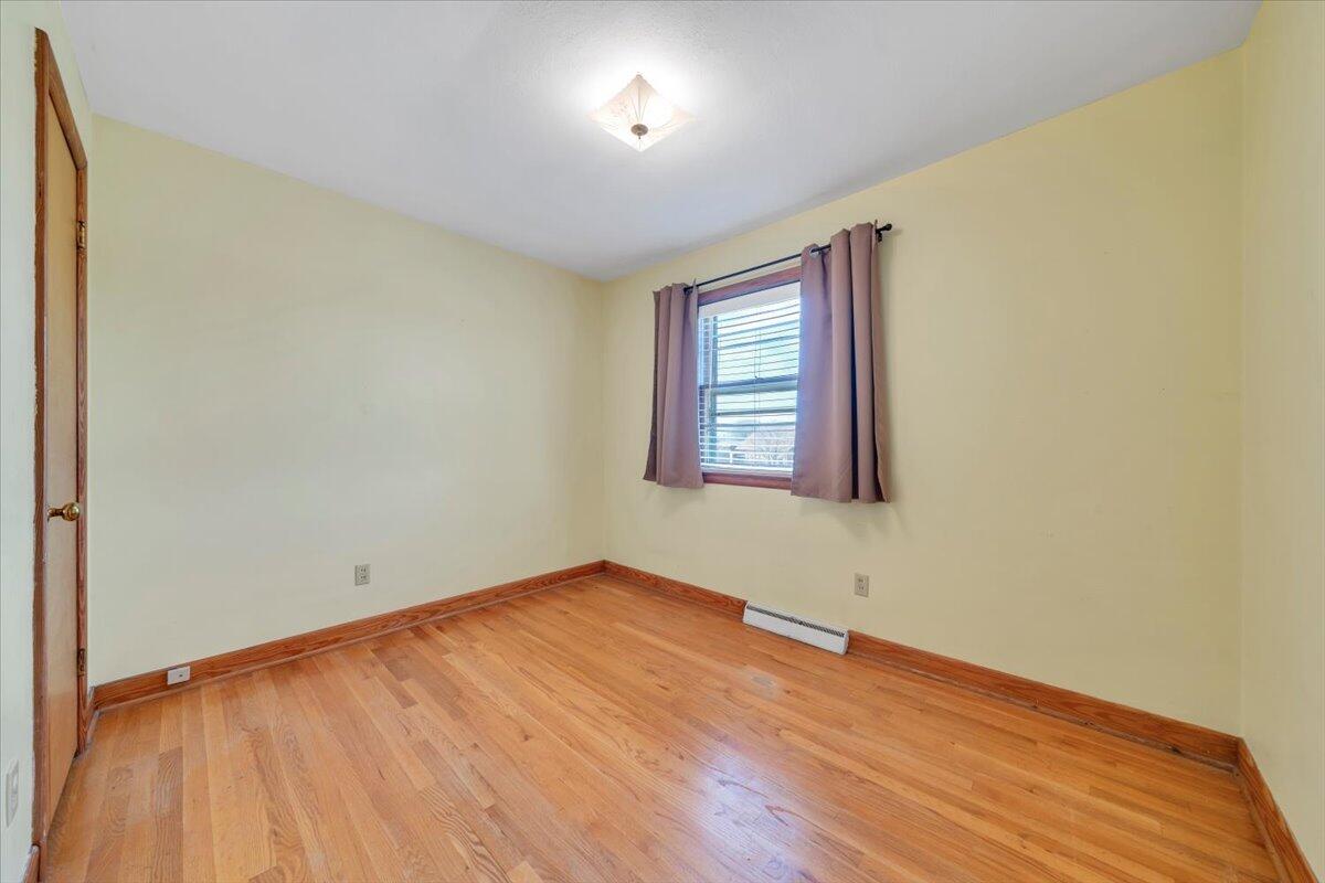2515 Northminster Road Northwest Roanoke, VA 24012 - Photo 24 of 54 an empty room with wooden floor and windows