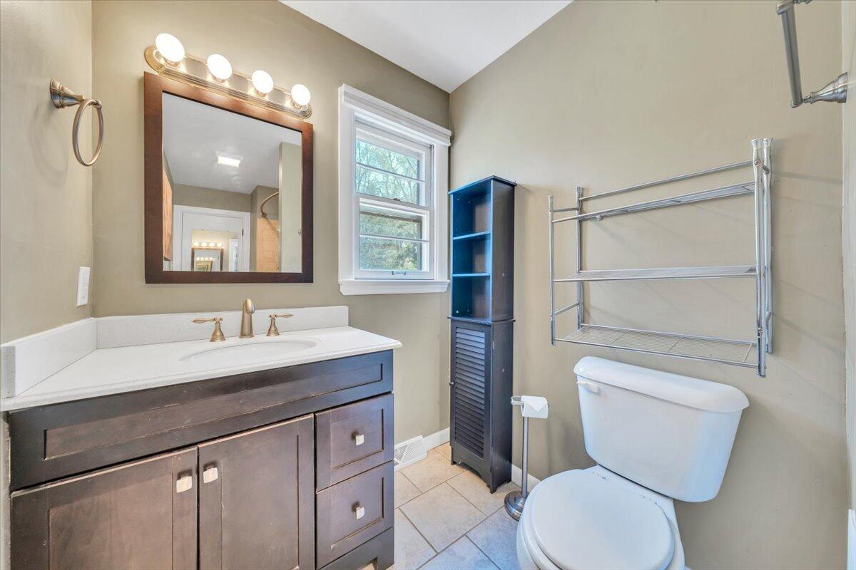 2515 Northminster Road Northwest Roanoke, VA 24012 - Photo 29 of 54 a bathroom with a toilet a sink and mirror