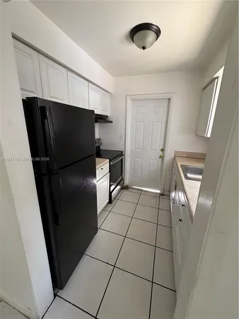 a kitchen with stainless steel appliances a refrigerator and a stove top oven