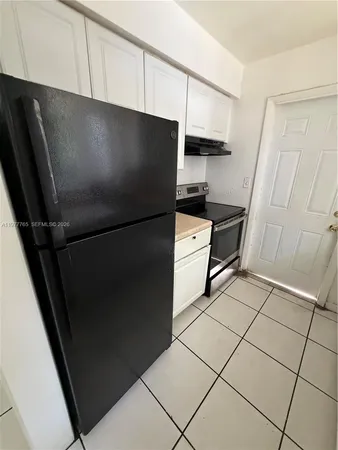 an aerial view of residential houses with outdoor space and swimming pool