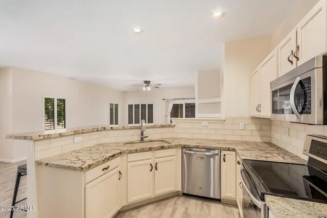 a kitchen that has a sink and a stove top oven