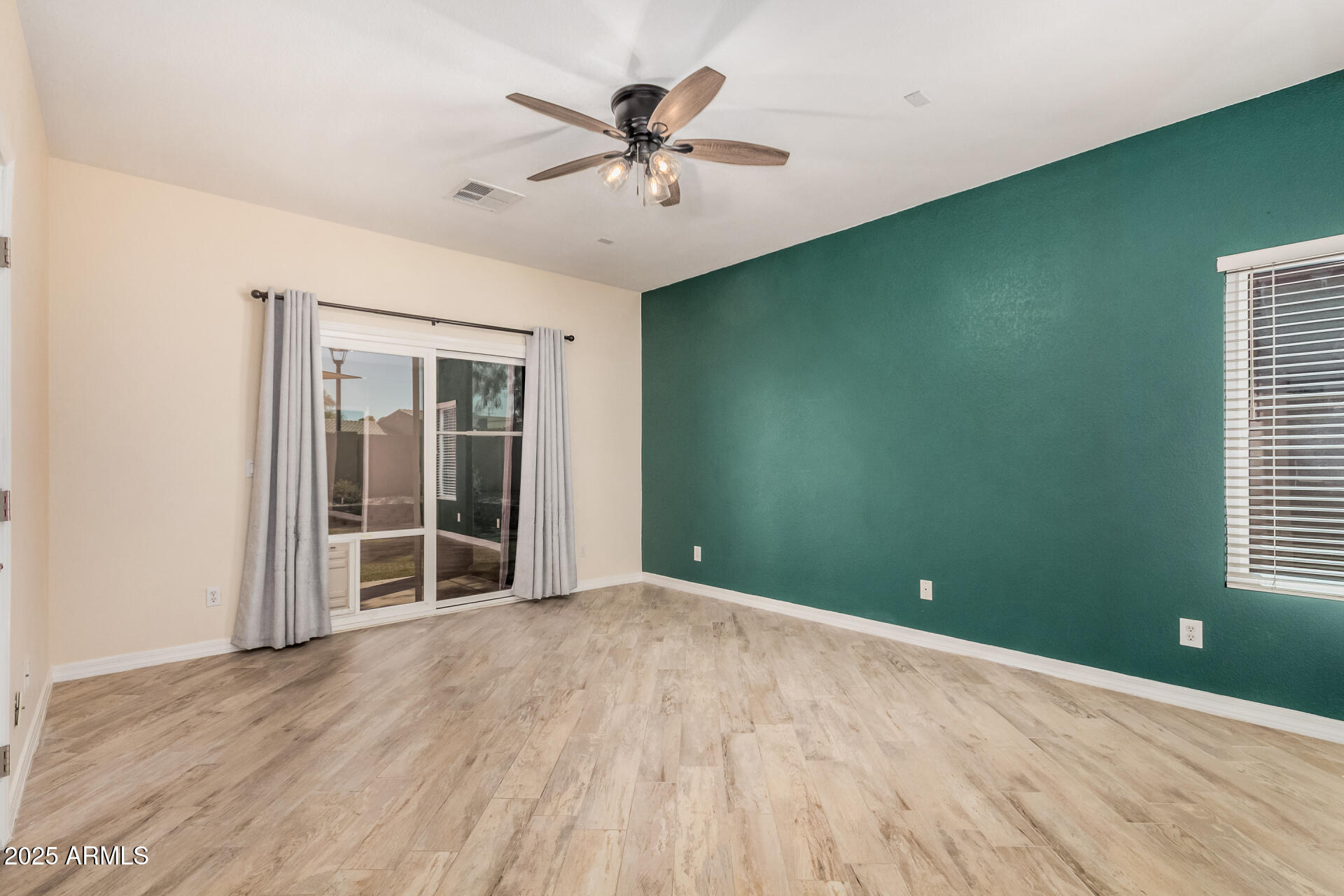 3047 East Fremont Road Phoenix, AZ 85042 - Photo 15 of 36 wooden floor in an empty room with a window