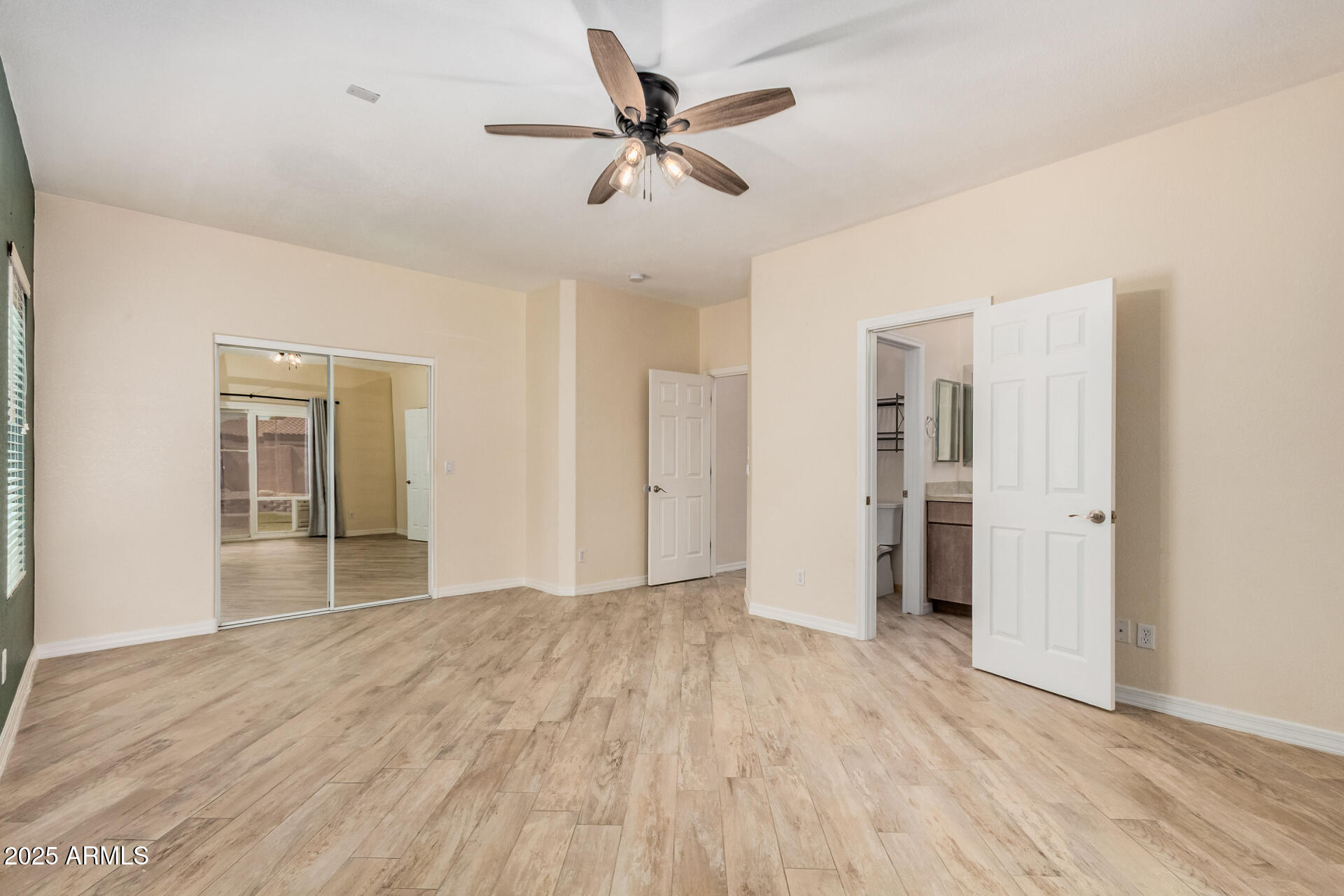 3047 East Fremont Road Phoenix, AZ 85042 - Photo 16 of 36 a view of empty room with wooden floor and ceiling fan