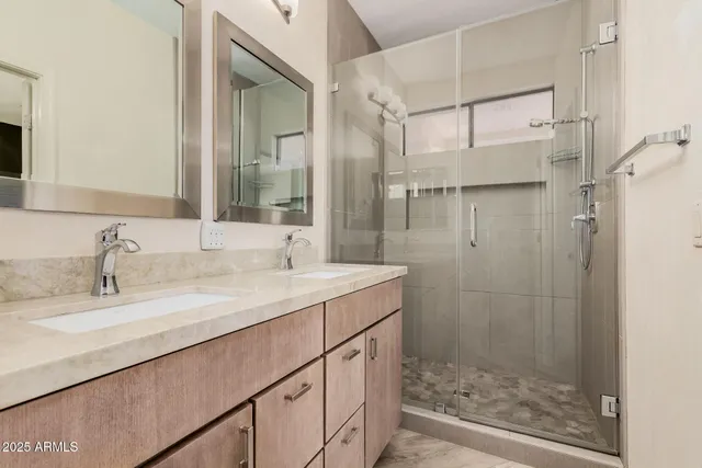 a bathroom with a shower sink and mirror