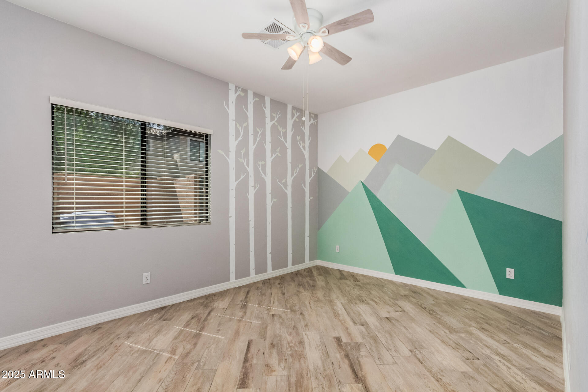 3047 East Fremont Road Phoenix, AZ 85042 - Photo 18 of 36 a view of empty room with wooden floor and fan