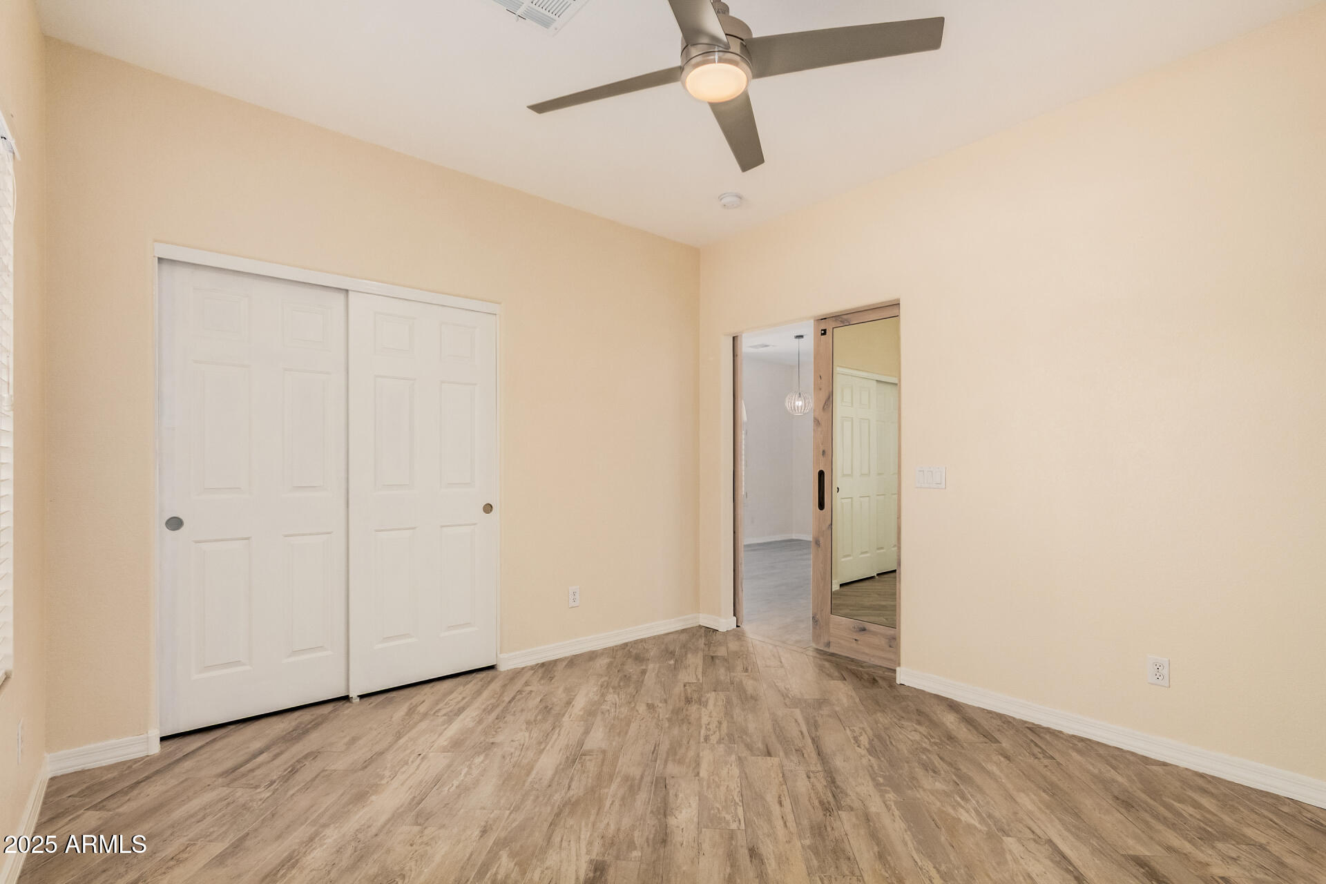 3047 East Fremont Road Phoenix, AZ 85042 - Photo 21 of 36 a view of an empty room with wooden floor