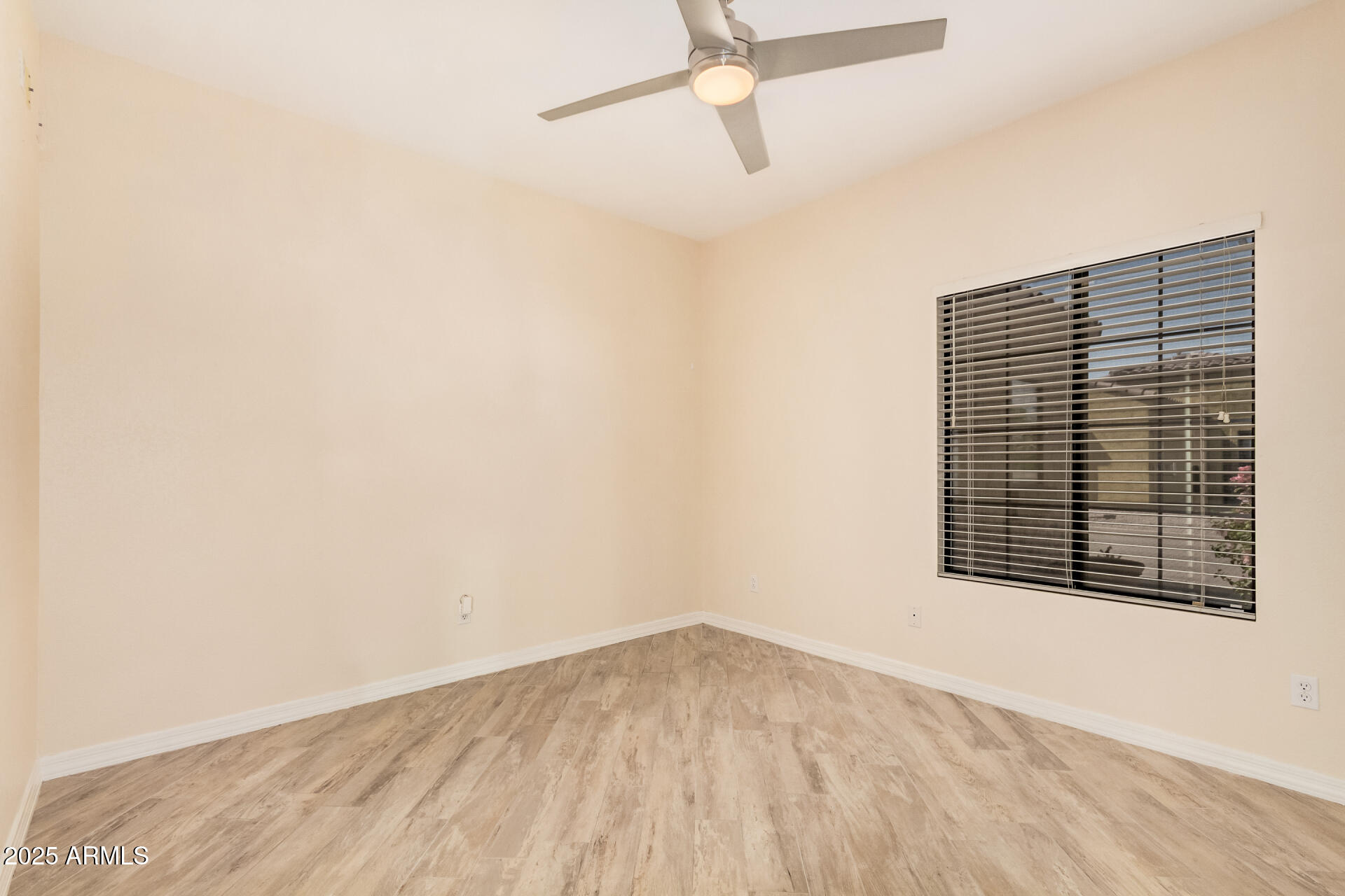 3047 East Fremont Road Phoenix, AZ 85042 - Photo 22 of 36 a view of an empty room with wooden floor and a window
