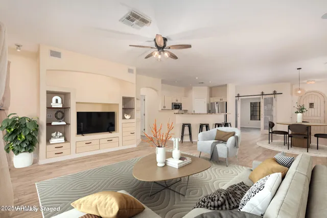 a living room with furniture a fireplace and a flat screen tv