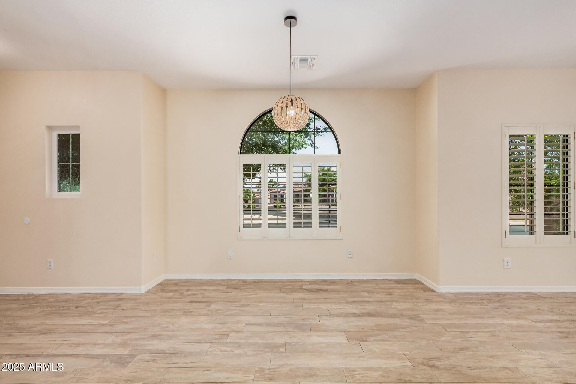 3047 East Fremont Road Phoenix, AZ 85042 - Photo 9 of 36 a view of a room window and wooden floor