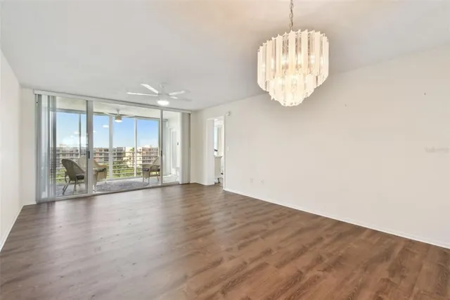 an empty room with wooden floor and mirror