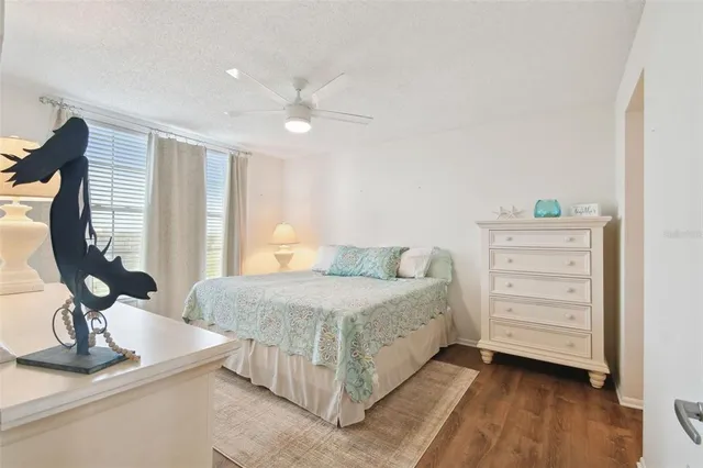 a bedroom with a bed and a lamp on the dresser