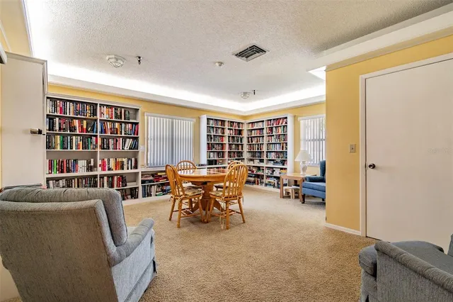 a room with pool table and windows