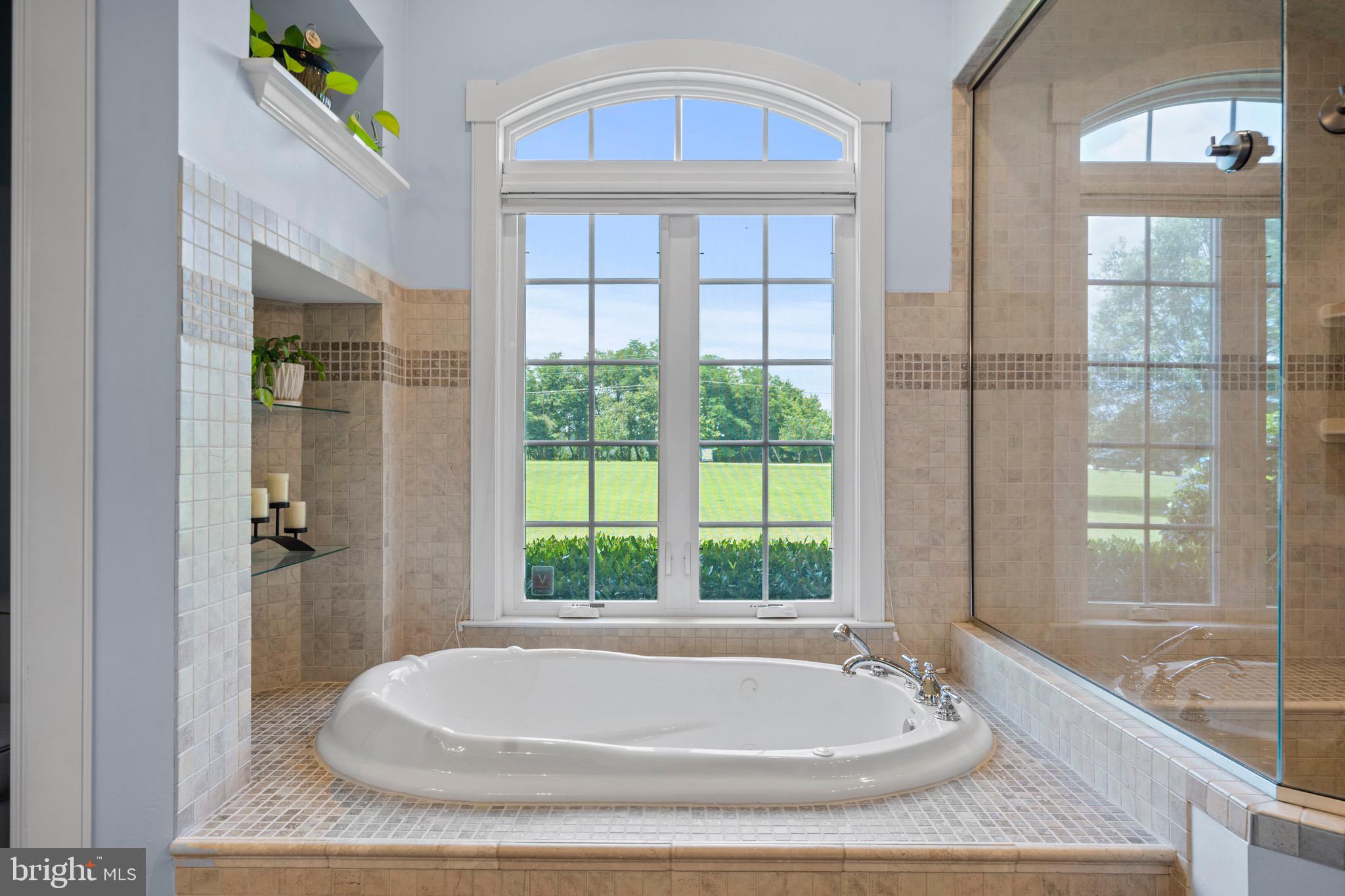 4160 Chaneyville Road Owings, MD 20736 - Photo 41 of 98 a bath tub sitting in front of a bathroom next to a window
