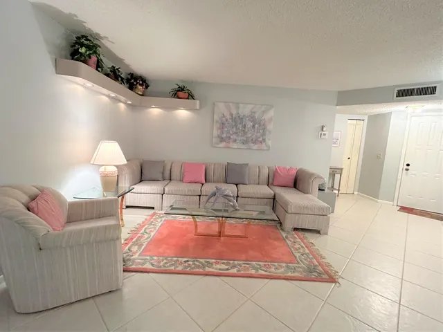 a living room with furniture chandelier and a chandelier