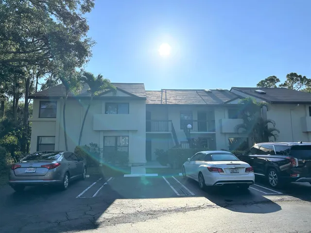 a view of a patio with couches and table and chairs and potted plants
