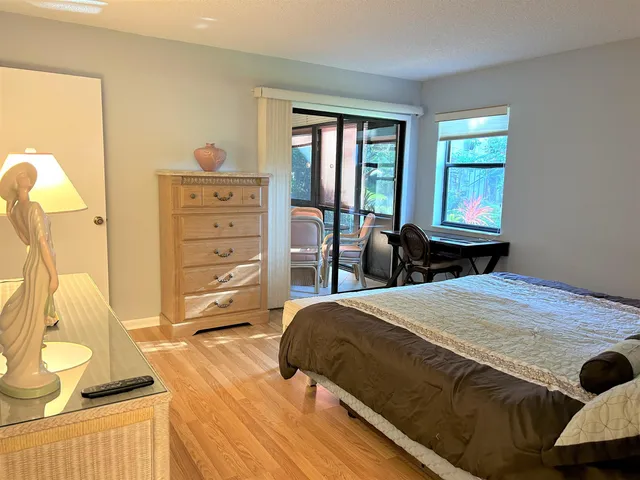 a bedroom with a bed window and a dresser