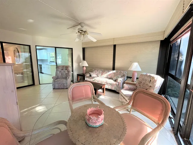 a view of a bedroom with a bed and wooden floor