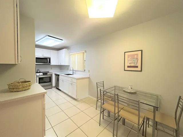 a kitchen with a sink cabinets and stainless steel appliances