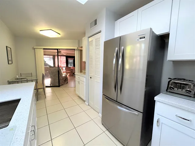 a kitchen with stainless steel appliances a refrigerator stove and sink