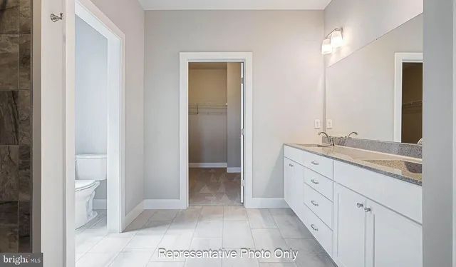 a bathroom with a double vanity sink and a mirror