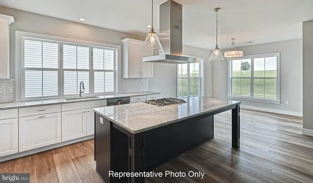 a kitchen with a sink window and wooden floor