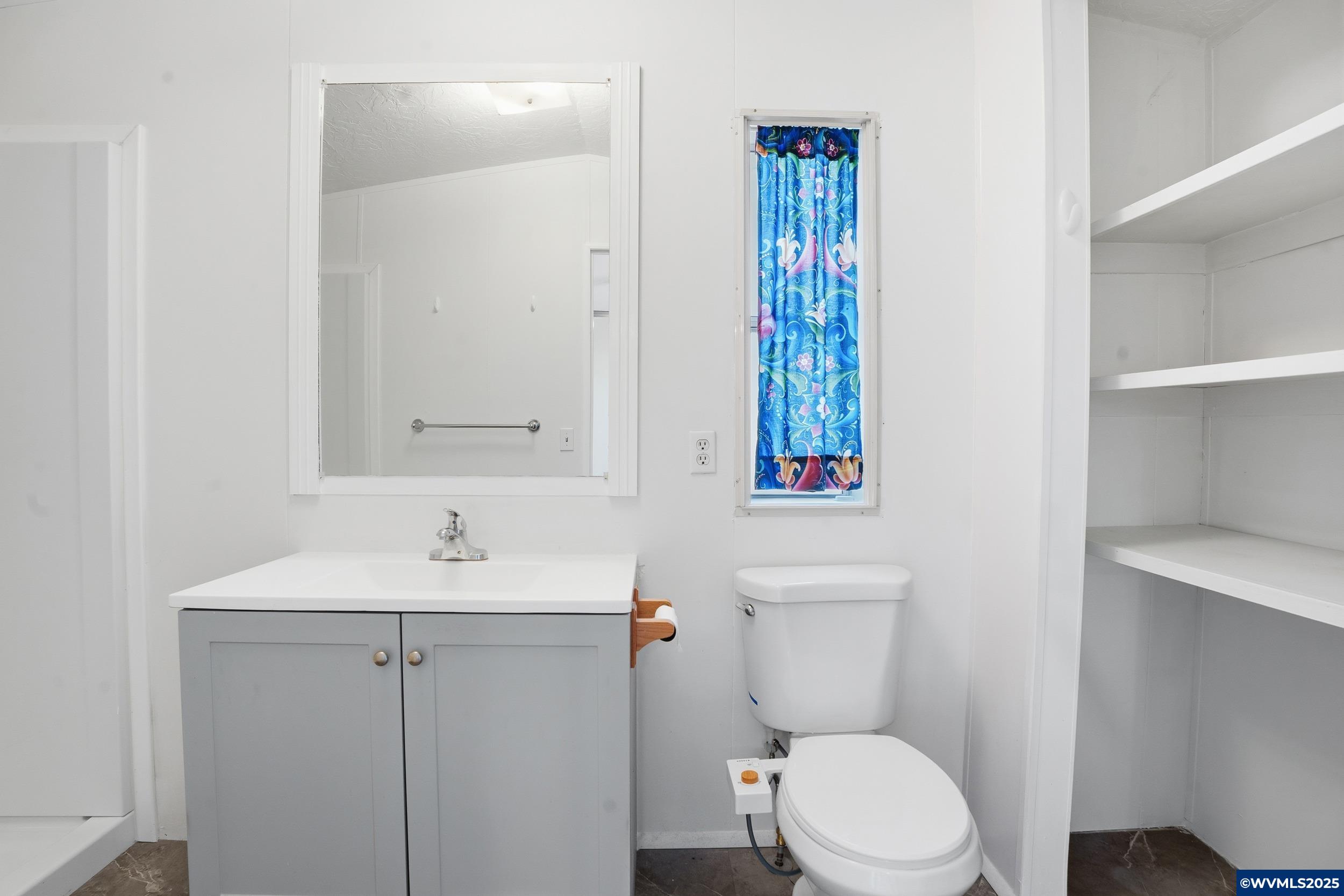 277 Edwards Road, Unit 145 Monmouth, OR 97361 - Photo 15 of 47 a bathroom with a sink a toilet and a mirror