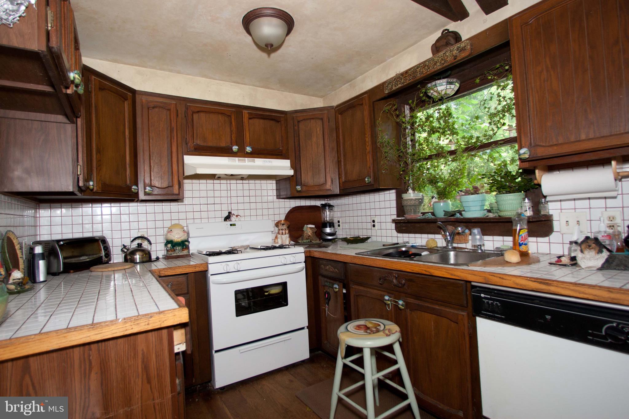 279 County Line Road Riegelsville, PA 18077 - Photo 12 of 24 a kitchen with a stove a sink a window and cabinets