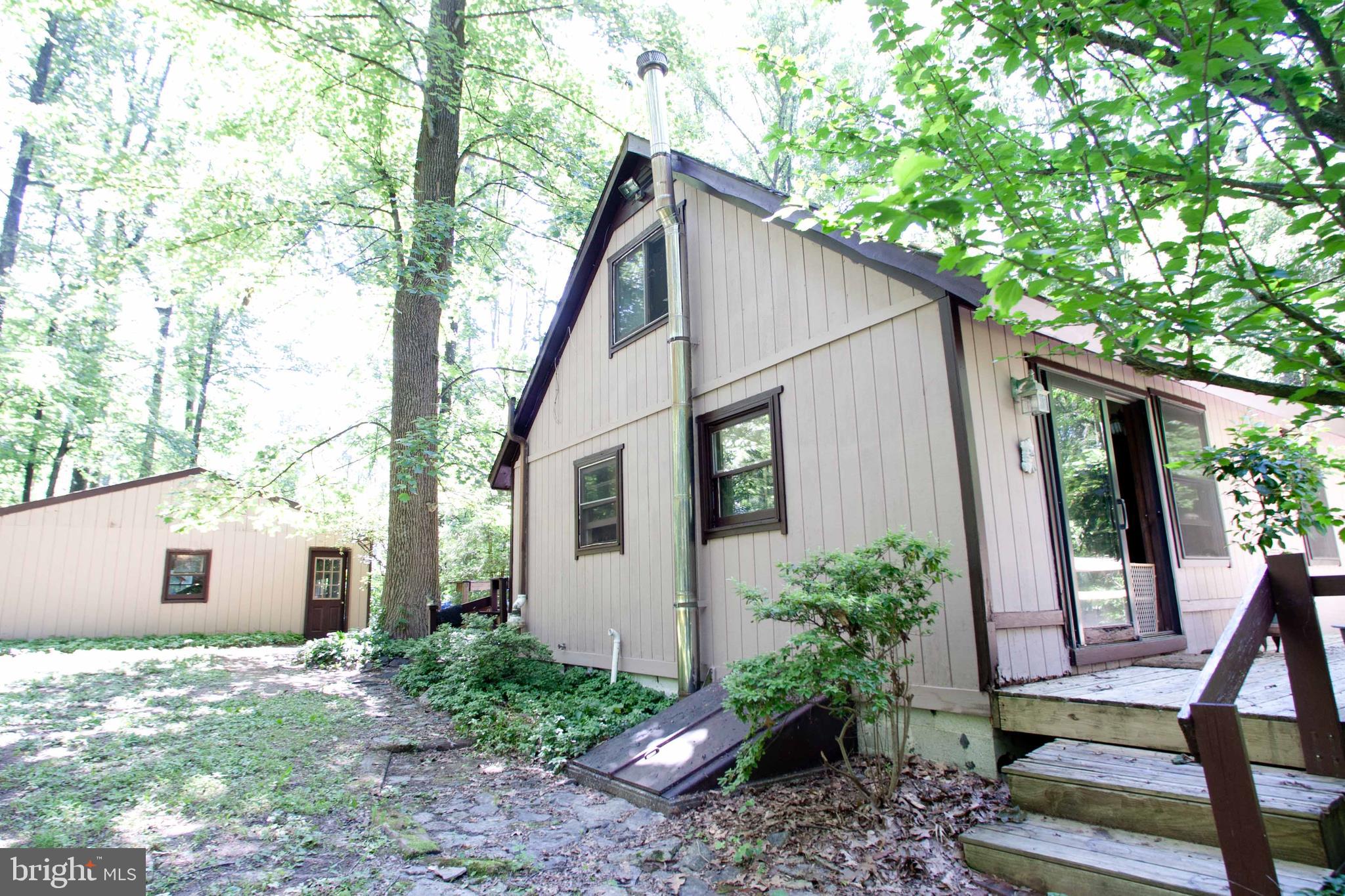 279 County Line Road Riegelsville, PA 18077 - Photo 21 of 24 a backyard of a house with plants and outdoor seating