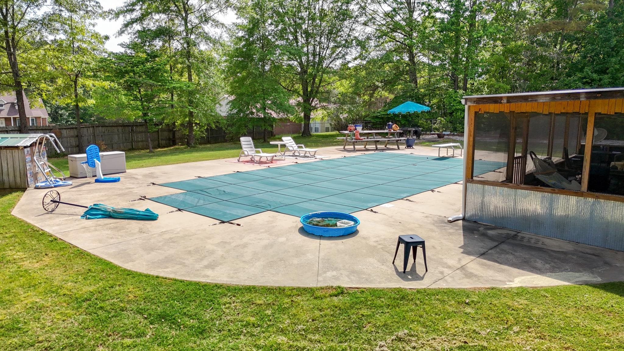 swimming pool view with a seating space
