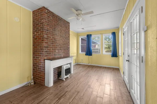 a living room with patio furniture and a floor to ceiling window