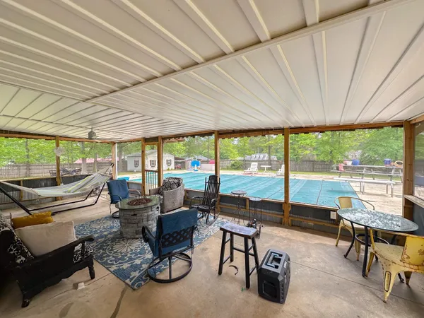 a view of house with backyard and seating space