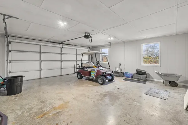 a front view of a house with a garden and trees