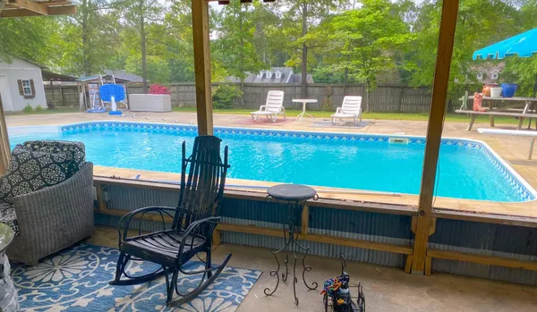 a living room with chairs and a table