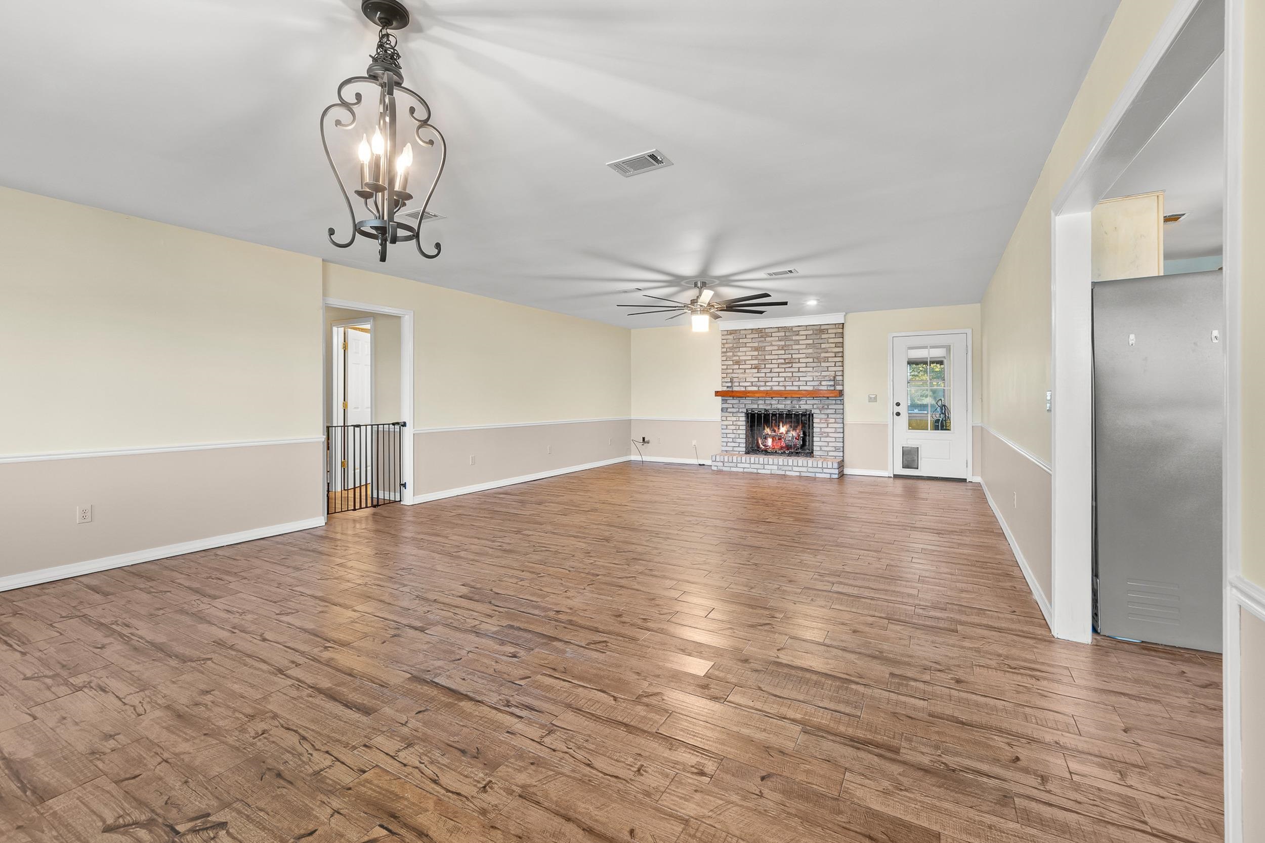 49 Cr 178 Road Iuka, MS 38852 - Photo 32 of 32 a view of a livingroom with wooden floor a ceiling fan and kitchen space