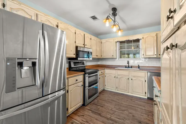 a kitchen with stainless steel appliances a refrigerator stove and microwave