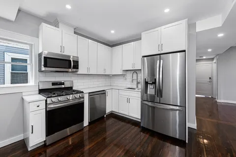 a kitchen with stainless steel appliances a refrigerator sink and microwave