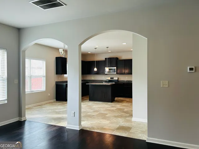 a kitchen with stainless steel appliances a refrigerator and a stove