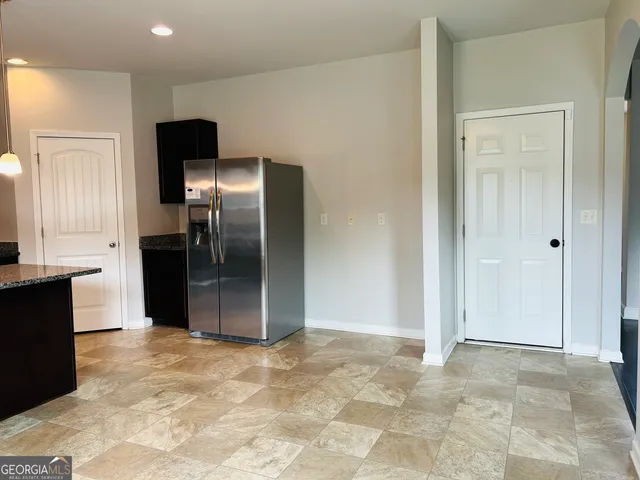 a view of kitchen with stainless steel appliances kitchen island