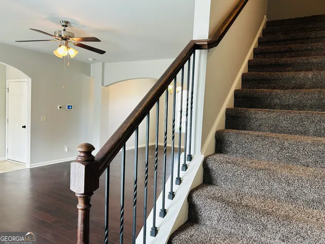 a view of a hallway with a door and wooden floor