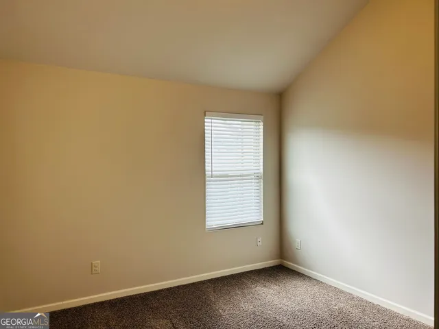a view of a closet area with hardwood floor